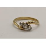 A gold ring with three diamonds in a rubover setting Location: