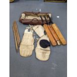 Vintage cricket items to include three vintage cricket bats, batsman padded leg guards, and