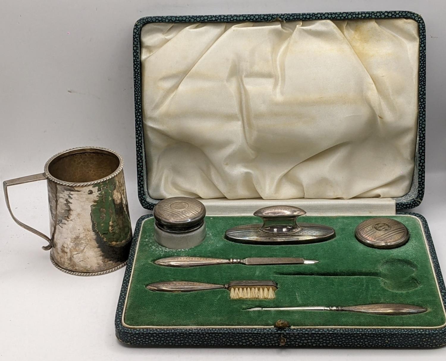 An early 20th century part silver manicure set A/F in a fitted case and an early 20th century silver