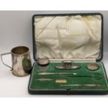 An early 20th century part silver manicure set A/F in a fitted case and an early 20th century silver