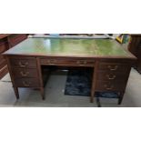 A mid 20th century mahogany twin pedestal writing desk having a green leather topped scriber and