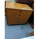 A teak G-plan four drawer chest of drawers raised on a plinth Location: