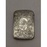 A late Victorian engraved vesta case with initials to the centre, hallmarked Birmingham 1881, 25.