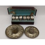 A boxed set of six silver embossed napkin rings, hallmarked Birmingham 1903, 47.8g together with two