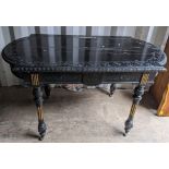 A Victorian ebonized hall table having egg and dart moulded moulded border, carved scroll design and