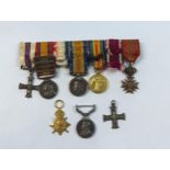 A miniature medal bar compromising of the Military Cross, Queen's South African medal WW1 British