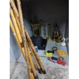 A mixed lot to include brass candlesticks, model cars, various walking sticks, and a shooting