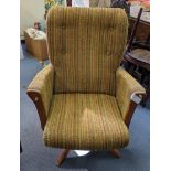 A mid 20th century striped upholstered rotating recliner armchair on a beech frame Location: