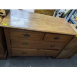 Early 20th century pine chest of two short and two long drawers on short turned legs and castors