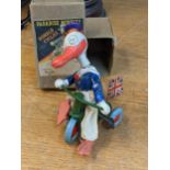 A Paradise Novelty Donald Duck cyclist, having a winking expression, long orange beak, white