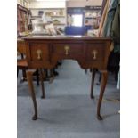 A reproduction of a George III mahogany low boy, the three drawers raised on cabriole legs and pad