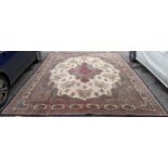 A large machine woven Persian design carpet having a central medallion, beige, ground an multi guard