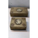 Two early 20th century Chinese brass engraved cigarette boxes, both inset with carved jade central