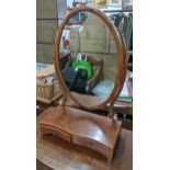 An Edwardian mahogany oval dressing table mirror with short drawers below 64h x 40w Location: