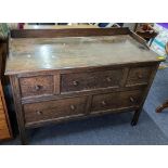 An early/mid 20th century oak chest of five drawers having a raised back and block shaped legs 89.