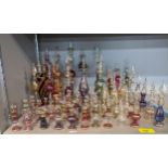 Perfume bottles of various designs and sizes, some of bulbous/ovoid form in a range of coloured