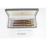 A cased set of Chinese lacquer Parker pens, comprising two fountain and one ballpoint pen, each with