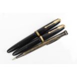 Two vintage Parker duofold fountain pens, with black body, gold trim, with arrow shaped clip and