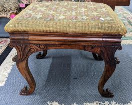 A 19th century tapestry topped footstool having a carved C-scroll frame and on cabriole legs,