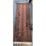 Two Persian hand woven to include a red grand rug having a elephant four motifs and tasselled ends