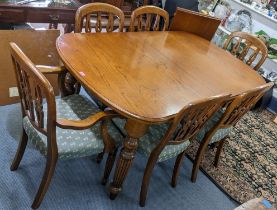 A John Lewis oak extending dining table with extra leaf and a set of six matching dining chairs,