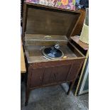 An early 20th century oak cased gramophone cabinet, standing on squared legs and spade feet, 87h x