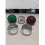 A collection of Whitefriars paperweights to include a green swirl paperweight, together with a