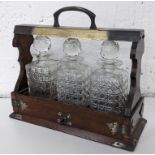 An early 20th century oak Tantalus with silver plated mounts, Location: