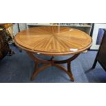 A reproduction mahogany circular topped dining table with reversable top games table on three reeded