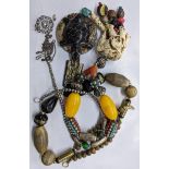 African jewellery two necklaces with various metal and wooden bead, one with faux ivory elephant and