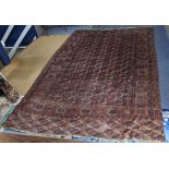 An Afghan hand woven rug having elephant foot motifs, geometric designs and tasselled ends, 328 x