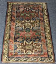 A Turkish hand woven rug having a blue ground with four motifs and beige border, 146 x 104.5,