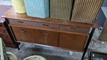 A mid 20th century Nathan teak and ebonized sideboard with three reeded drawers and three doors, 84H