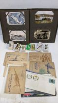 A selection of cigarette cards together with a postcard album Location: