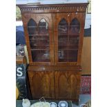 A Victorian mahogany gothic inspired bookcase having glazed doors above two paralleled doors and a