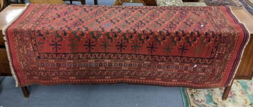 A hand woven Turkish rug having a red round, multiguard borders and tasselled ends, 184 x 128,