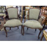 A pair of late 20th century Louis XV style stained beech framed armchairs with green upholstery