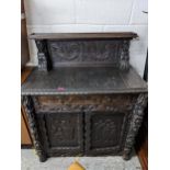 A 19th century and later carved oak cabinet with panelled back, drawer and a pair of doors Location: