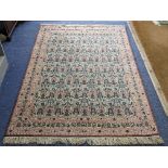 A South East Persian Zili Sultan hand woven rug having an ivory ground and decorated with birds