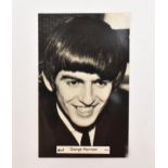 A photograph postcard of George Harrison, with pencil signature to the reverse, believed to be by
