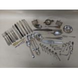 A mixed lot of silver plate to include two toast racks, a tea strainer, grape scissors, fish fork