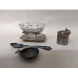 A group of silver and white metal items to include a caddy spoon, Victorian mustard pot, silver