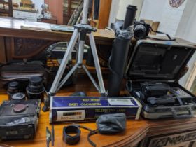 A selection of film cameras, lens, and accessories to include a Minolta 7000 with zoom lens 70-
