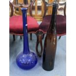 A large Bristol blue glass bottle vase, 70cm h, and a brown glass bottle Location: