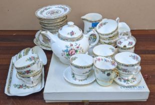 A Coalport Ming Rose pattern tea set with twelve cups, saucers, plates, a tea pot and other items