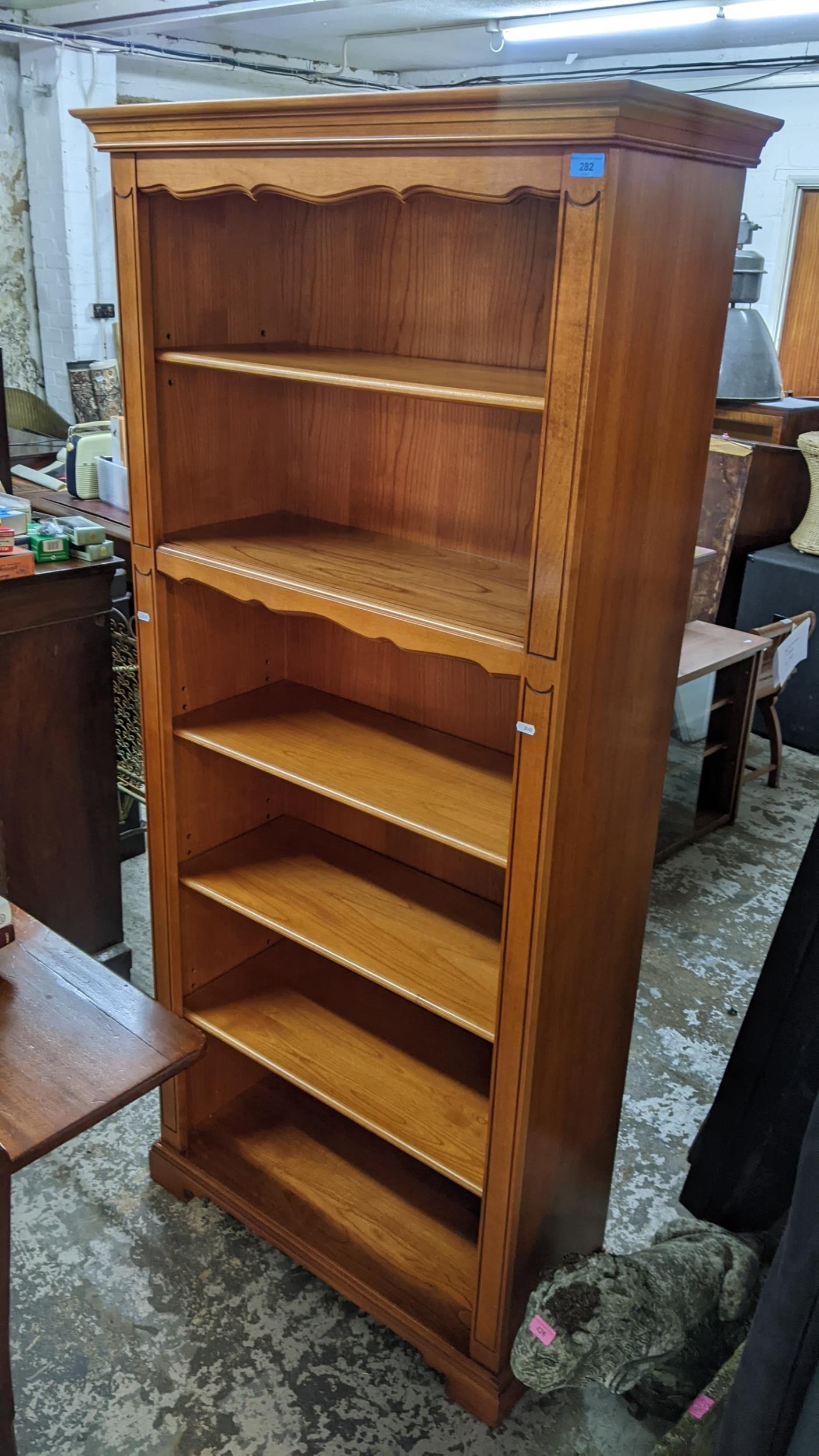 A modern Younger six tier open bookcase having a stepped cornice and bracket shaped feet, 181.5cm