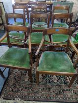 A set of eight Regency mahogany dining chairs with green covered upholstered drop-in seats,