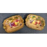 A pair of Royal Worcester side dishes decorated with a gold coloured gilding and handles,