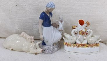 A Royal Copenhagen ornament of a lady with a goat, numbered 2180, together with a Beswick pig and
