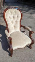 A Victorian walnut salon carved armchair on cabriole front legs Location: